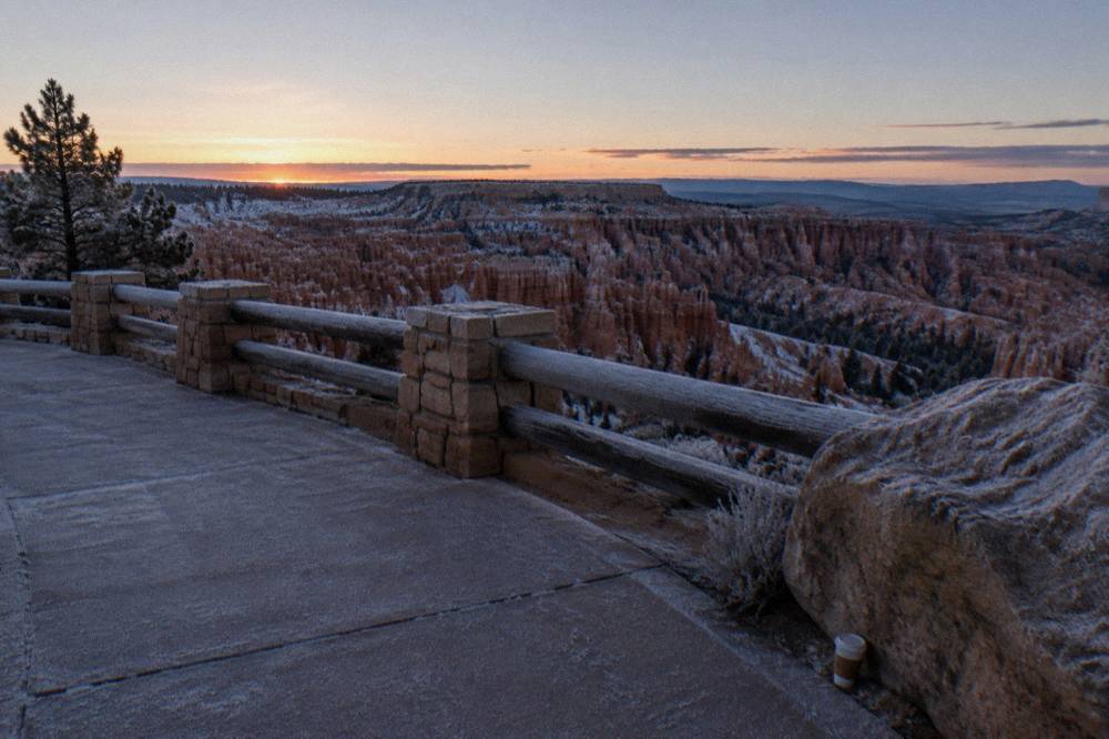 A nearly empty sunrise overlook terrace in cold predawn light